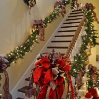 Stairway Decorated with Lit Garland and Ribbon for Christmas