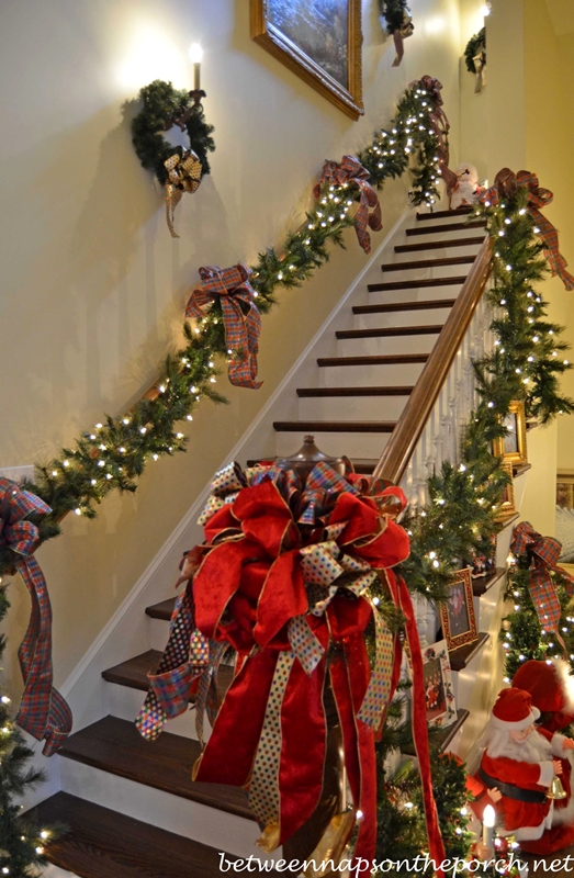 Stairway Decorated with Lit Garland and Ribbon for Christmas