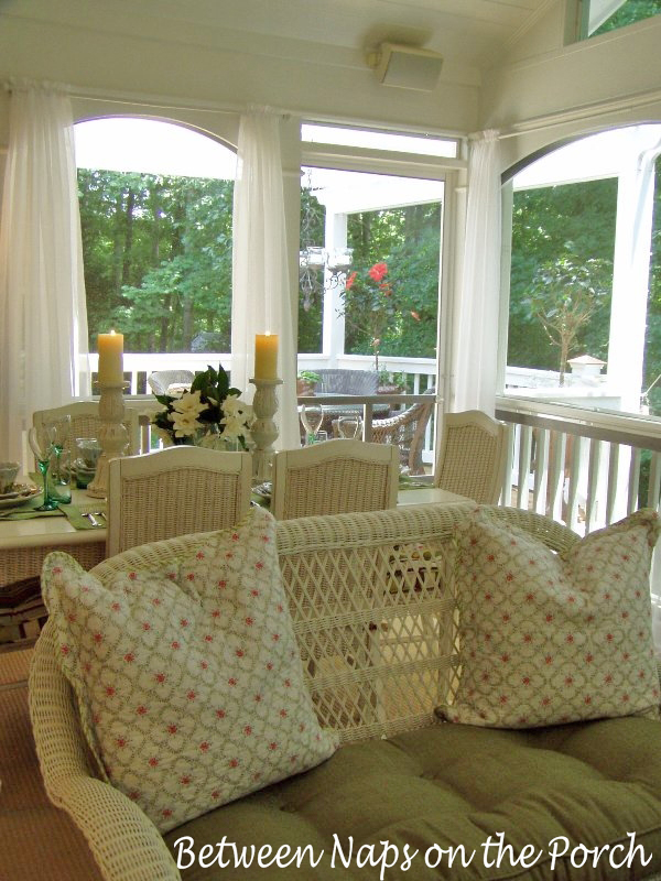 Screened Porch with Sheer Curtains and White Wicker Furniture