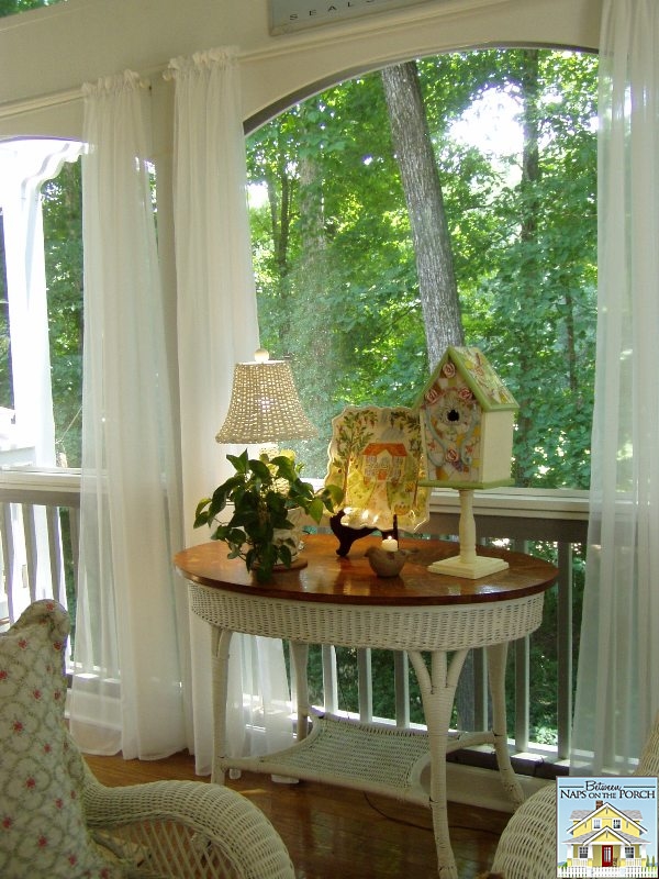 Screened Porch with Wicker Furniture and Mosaic Birdhouse