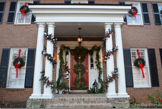 Porch decorated with garland and wreaths for Christmas