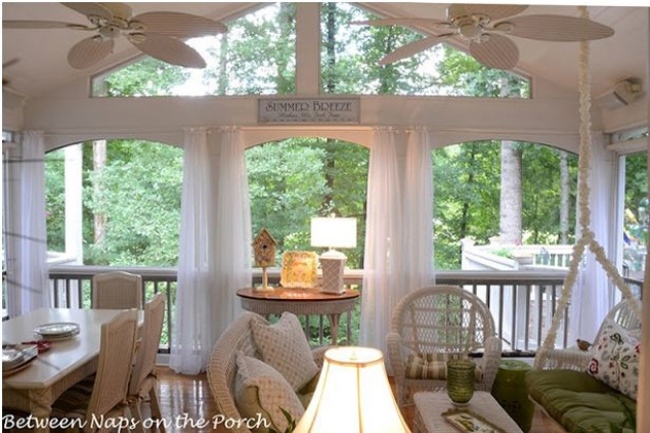Screened Porch with Sheer Curtains and White Wicker Furniture