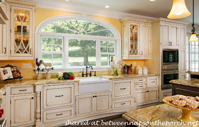 French Country Kitchen with Yellow Walls and Antiqued Cabinets