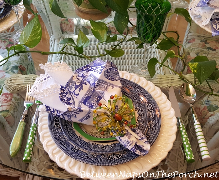 Blue and White Table Setting with Green Stemware and Flatware