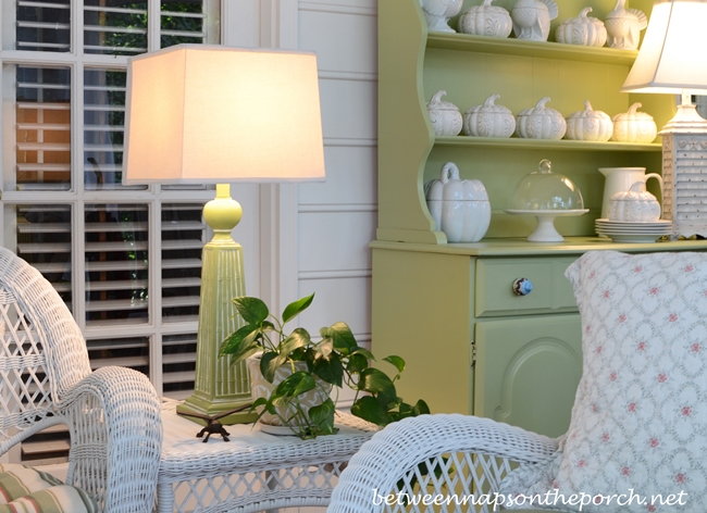 Green & White Porch Decorated in White Wicker