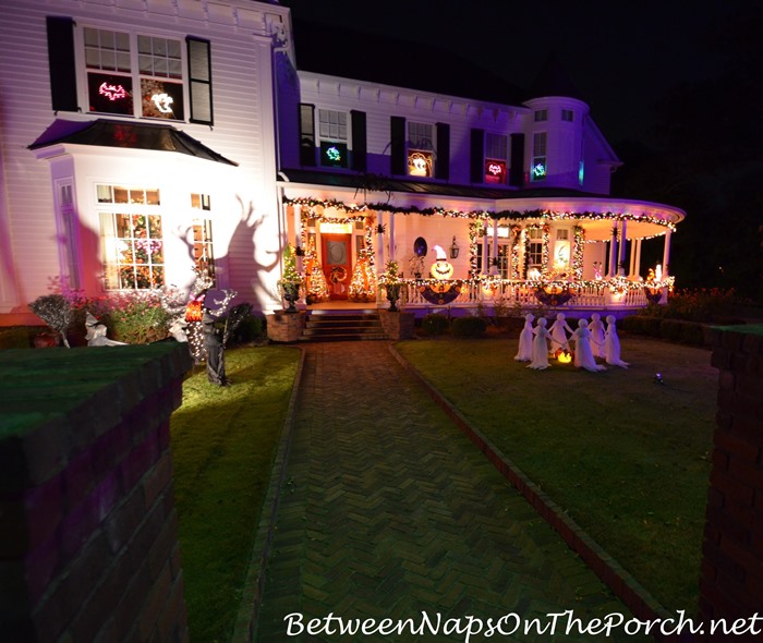 victorian-home-lit-for-halloween-ghosts-and-witches-on-the-lawn_wm