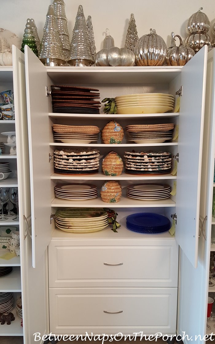 Charger Plates Stored in White Cabinet, Napkin Storage Below