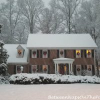 Christmas House with Wreaths in Snow