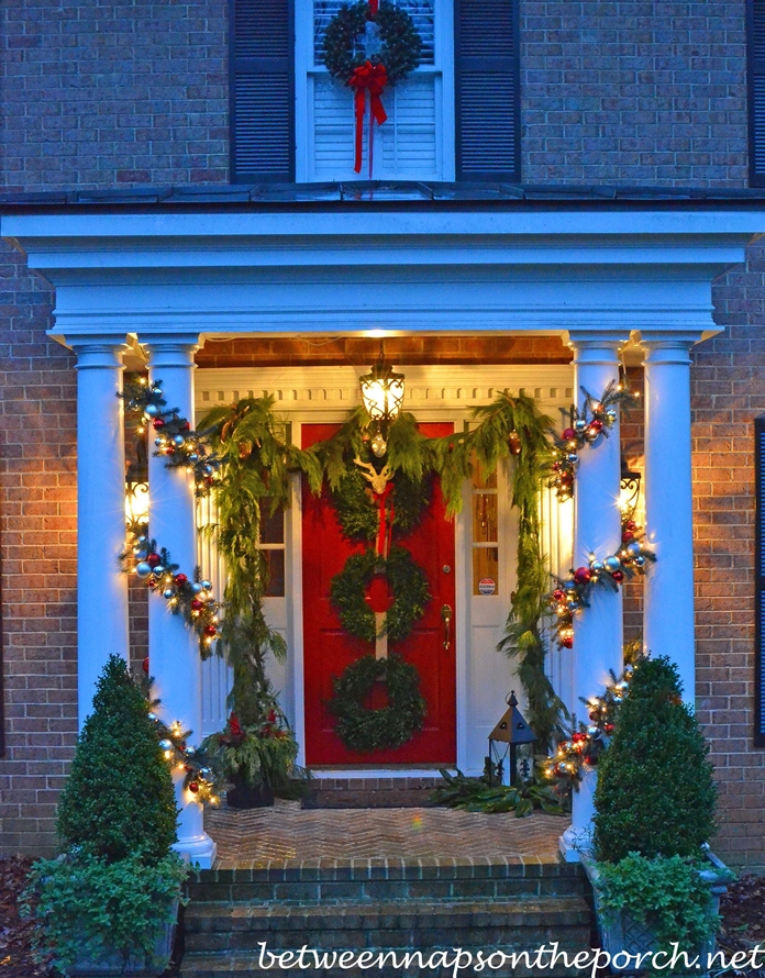 Christmas Porch Decorated with Garland and Boxwood Wreaths