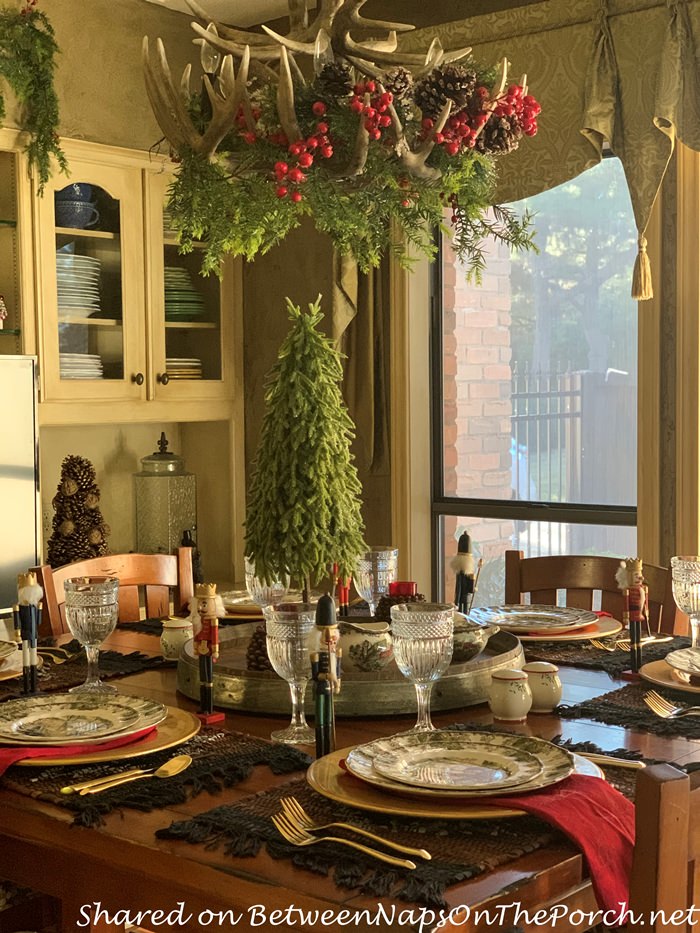 Christmas Antler Chandelier Decorated with Greenery, Pinecones and Berries