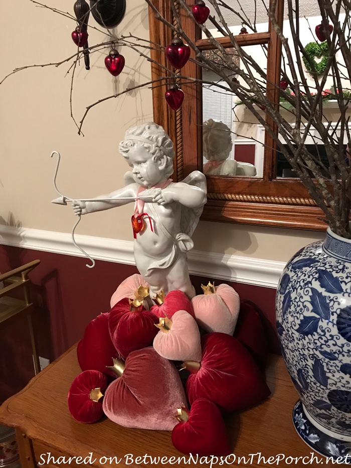 Cupid Surrounded by Velvet Hearts