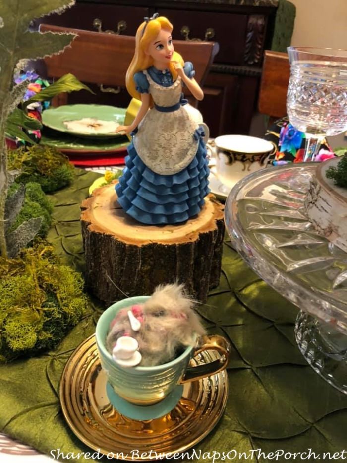 https://betweennapsontheporch.net/wp-content/uploads/2021/04/Alice-in-Wonderland-Table-Setting-Dormouse-asleep-in-cup.jpg