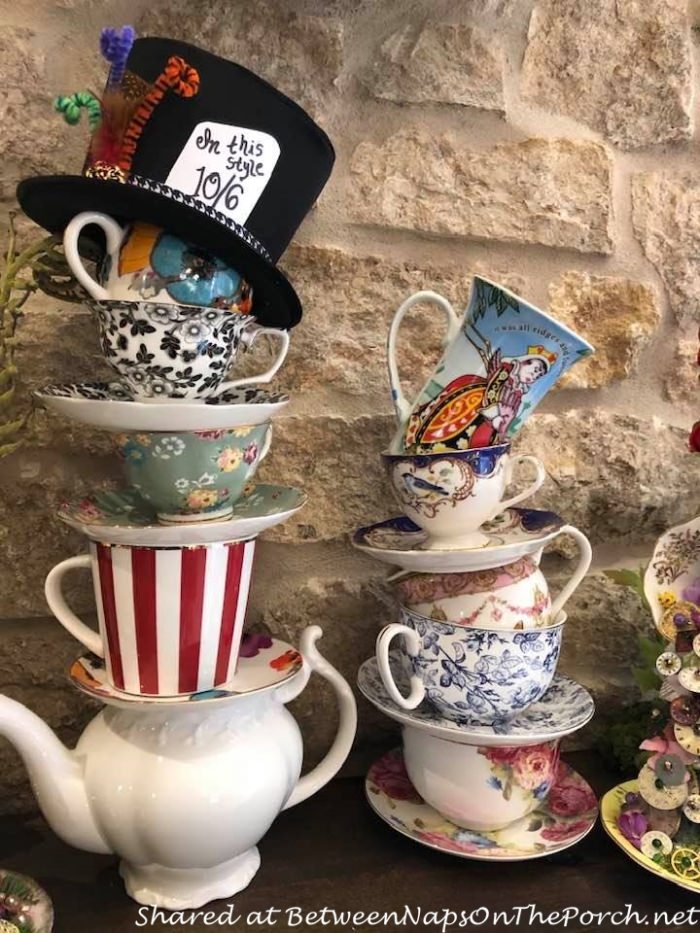 https://betweennapsontheporch.net/wp-content/uploads/2021/04/Alice-in-Wonderland-Talking-Flowers-Two-tipsy-teacup-towers-on-the-fireplace-mantle.jpg